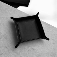 Load image into Gallery viewer, A Handmade Black Leather Desk Tidy Valet Tray, with raised corners and stitched edges, photographed from above on a light grey textured surface.