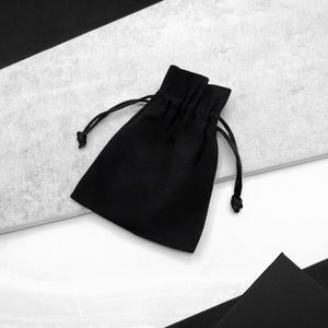 Black luxury Parker & Co. Small cotton gift bag, styled on a modern monochrome background.