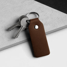 Load image into Gallery viewer, Handmade Thick Dark Brown Leather Fob Keyring on a grey and white stone surface