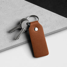 Load image into Gallery viewer, Handmade Thick Light Brown Leather Fob Keyring on a grey and white stone surface