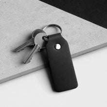 Load image into Gallery viewer, Handmade Thick Black Leather Fob Keyring on a grey and white stone surface
