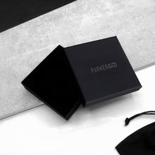Load image into Gallery viewer, Black Parker &amp; Co. gift box with minimalist branding, styled on a modern monochrome background.