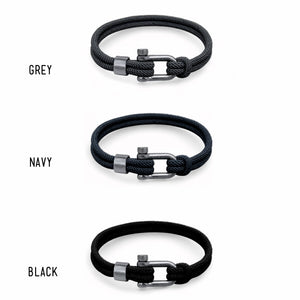 Three black bracelets with silver clasps labeled 'Grey', 'Navy', and 'Black' on a white background.